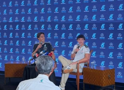 George Russell (left) with teammate Kimi Antonelli. - Sinar Daily photo