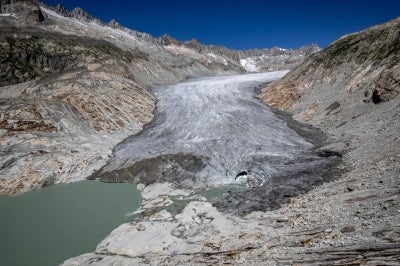 This aerial photograph shows the melting Rhone Glacier, above Gletsch, in the Swiss Alps. (Photo by Fabrice COFFRINI / AFP)