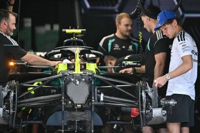Mercedes' Italian driver Kimi Antonelli (right) looks at his vehicle in the garage, ahead of the Formula One Bahrain Grand Prix, in Sepang. -AFP Photo
