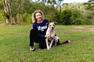 This handout photo Taken on May 25, 2026 and provided by the International Fund for Animal Welfare (IFAW) shows IFAW's Josey Sharrad posing for pictures with Oaka, a rescue dog undergoing training to become Australia's next koala detection dog, following the retirement of the renowned koala detection dog Bear. - (Photo by Handout / IFAW / AFP)