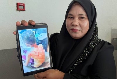 The boy’s mother, Rosnani Mat Salleh, 46, said her son, Azuar Firdaus Zuraiman, showed positive progress today after remaining withdrawn for two days as he was still traumatised by the incident. - Photo by Bernama