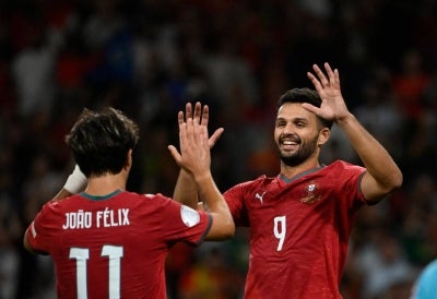 Portugal's forward #09 Goncalo Ramos celebrates with Portugal's forward #11 Joao Felix. (Photo by Miguel RIOPA / AFP)