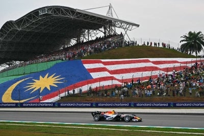 Racing Bulls' New Zealand driver Liam Lawson steers his car during the Formula One Bahrain Grand Prix in Sepang on October 4, 2026. (Photo by Lillian SUWANRUMPHA / AFP)