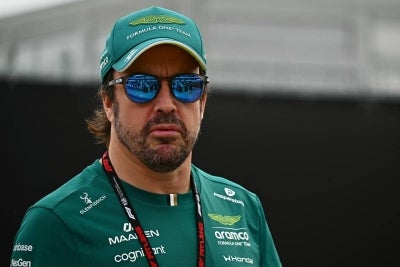 Aston Martin's Spanish driver Fernando Alonso arrives ahead of the Formula One Bahrain Grand Prix in Sepang on October 4, 2026. (Photo by Lillian SUWANRUMPHA / AFP)