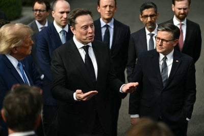 US President Donald Trump and US Speaker of the House Mike Johnson (R) look on as CEO of Tesla and SpaceX Elon Musk speaks to the press. (Photo by Kent NISHIMURA / AFP)