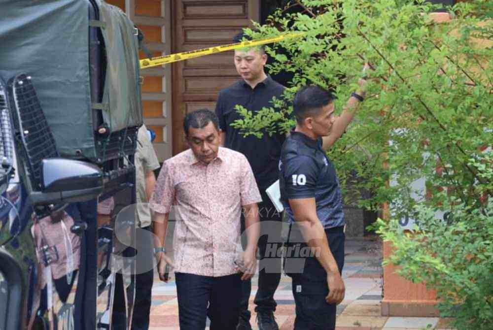 Ashari (front) with investigating team at the murder scene.