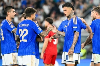 Italy's forward #11 Gianluca Scamacca (2nd R) celebrates after scoring with his teammate Italy's defender #22 Giovanni Di Lorenzo. (Photo by Alberto PIZZOLI / AFP)
