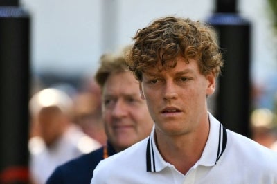 Italian tennis player Jannik Sinner (R) (Photo by Marco BERTORELLO / AFP)