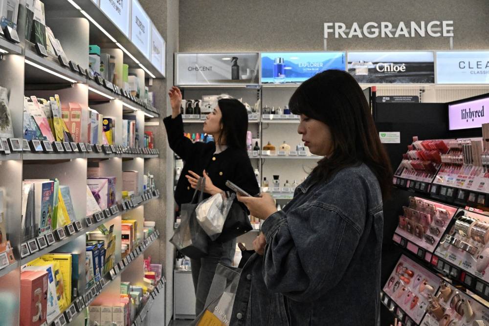 Women buy products in a store in Seoul on April 3, 2025. (Photo by Pedro PARDO / AFP)
