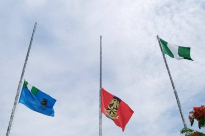 The flags of the Nigerian Army and Nigerian Air Force are seen at half-mast during a military burial ceremony to honour the officers killed in a plane crash, at the National Military Cemetery, Abuja, Nigeria on May 22, 2021. AFP FILE PIX