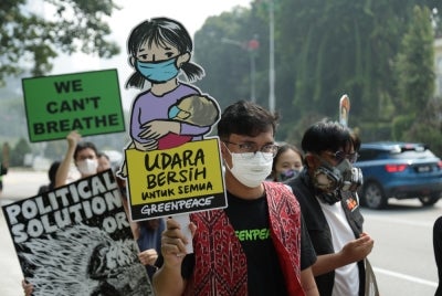 Civil society groups march from Tugu Negara to Parliament in Kuala Lumpur on Oct 7, 2026, calling for stronger action to address transboundary haze and hold companies accountable.