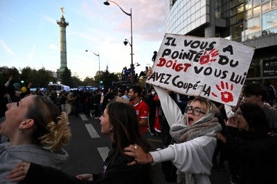 Protesters chant slogans during a demonstration of high-school students at Place de la Bastille, in Paris, on October 8, 2026. Photo by JULIEN DE ROSA / AFP)