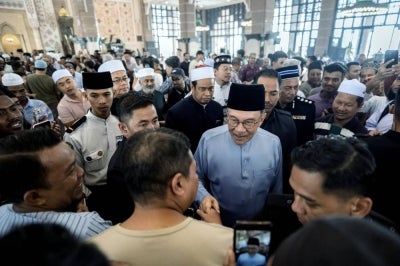 PUTRAJAYA, Oct 9 -- Prime Minister Datuk Seri Anwar Ibrahim shakes hands with congregants after performing Friday prayers at Putra Mosque today. - BERNAMA PHOTO (2026) COPYRIGHT RESERVED
