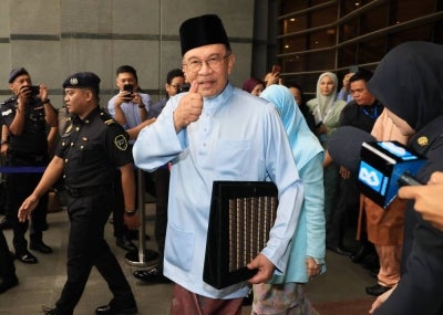 Prime Minister Datuk Seri Anwar Ibrahim, who is also Finance Minister, gives a thumbs-up before leaving for Parliament to table Budget 2027 today. - Photo by Bernama