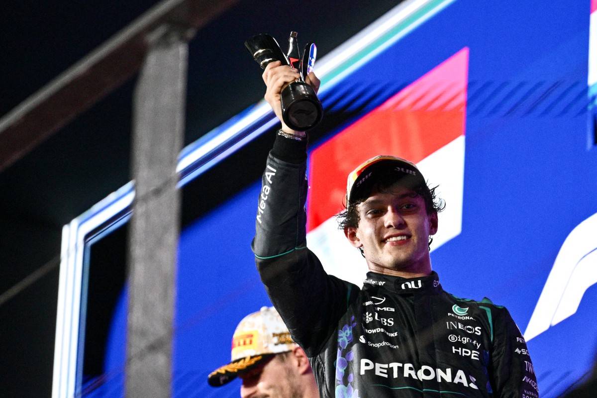 Third-placed Mercedes' Italian driver Kimi Antonelli lifts his trophy as he celebrates on the podium after the Formula One Singapore Grand Prix at the Marina Bay Street Circuit in Singapore on October 11, 2026. (Photo by ANTHONY WALLACE / AFP)