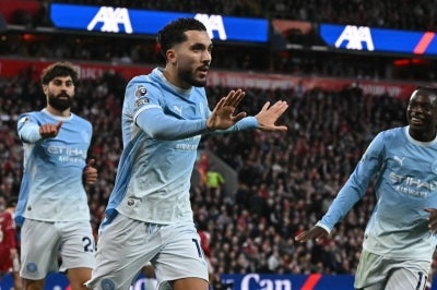 Manchester City's French midfielder #10 Rayan Cherki (C) celebrates scoring the third goal during the English Premier League football match between Liverpool and Manchester City at Anfield in Liverpool, north west England on October 11, 2026. (Photo by Paul ELLIS / AFP)