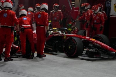 Ferrari's British driver Lewis Hamilton drives out of the pit lane during the Formula One Singapore Grand Prix at the Marina Bay Street Circuit in Singapore on October 11, 2026. (Photo by Ng Han Guan / POOL / AFP)