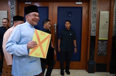 Prime Minister Datuk Seri Anwar Ibrahim showing the Budget 2027 document on Friday. Bernama FILE PIX