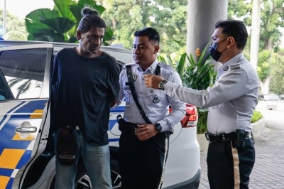 Lorry driver C. Agilan, 51, pleaded not guilty in the Shah Alam magistrate's court to driving against traffic under the influence of drugs and causing injuries to four other individuals last week. - Photo by Bernama