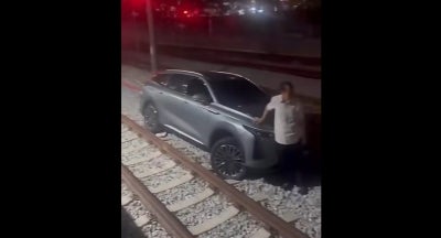 A screengrab from a video shared on social media shows a car on railway tracks after a 60-year-old man drove along them before reaching a KTMB station.