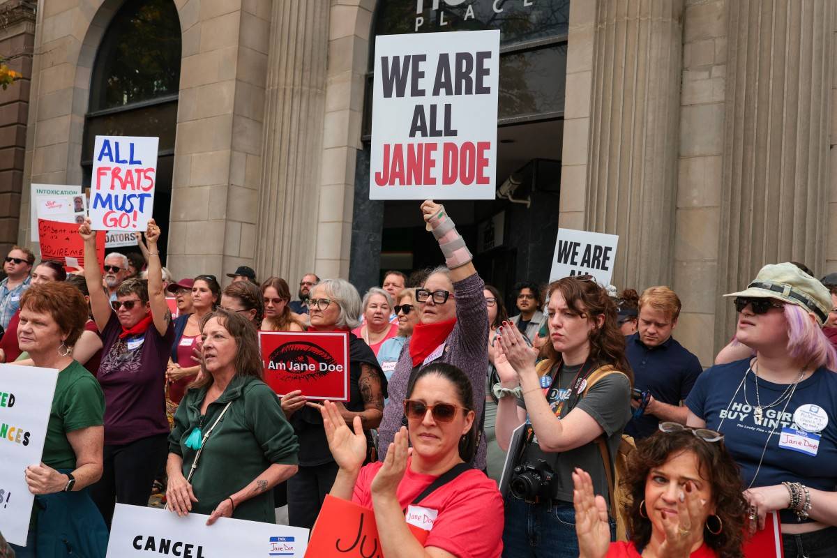 Protesters listen to speakers at a rally in support of a former Cornell University student known as Jane Doe at the Ithaca Commons on October 13, 2026 in Ithaca, New York. (Photo by Anna Moneymaker / GETTY IMAGES NORTH AMERICA / Getty Images via AFP)