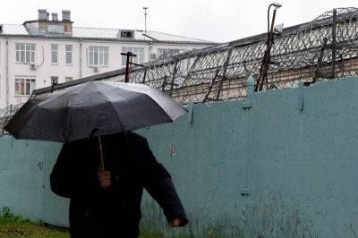 A person walks past Moscow's high-security Lefortovo prison, used to jail those being investigated by the FSB security services, on October 14, 2026. (Photo by TATYANA MAKEYEVA / AFP)