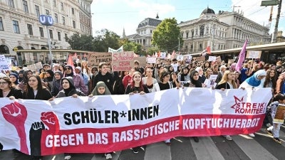 Young protesters hold a banner reading "Students against the racist headscarf ban" as they take part in a demonstration against a headscarf ban in schools, on October 9, 2026 in Vienna, Austria. (Photo by Joe Klamar / AFP)