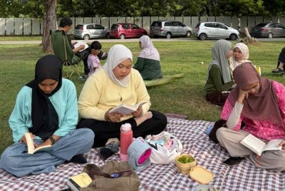 The relaxed atmosphere of the Silent Reading Picnic program in Kuala Terengganu brings together book lovers of all ages to spend time reading their favorite manuscripts. (SINAR PHOTO)
