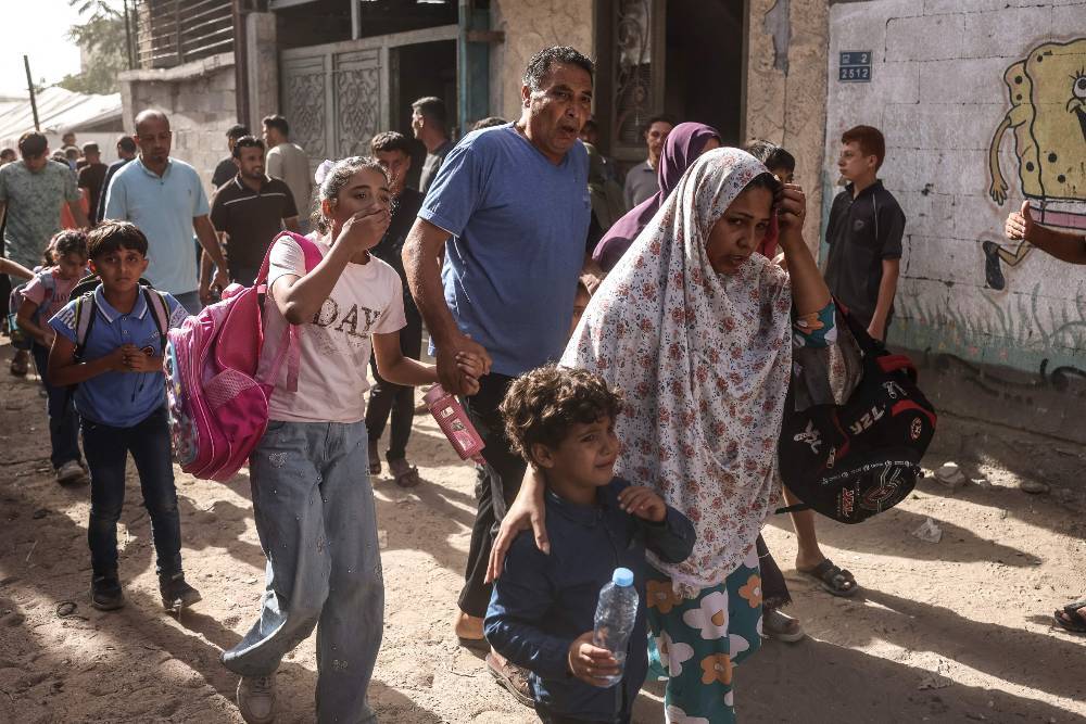 Palestinian school children are ushered away from the site of an Israeli drone strike that reportedly killed one Palestinian in Jabalia in the northern Gaza Strip on October 15, 2026. Despite a US-backed ceasefire that took effect in October 2025, violence has not halted in the Gaza Strip, with Israel continuing to target Palestinians it says are militants. -AFP Photo