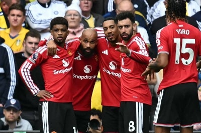 Manchester United's Cameroonian midfielder #19 Bryan Mbeumo (2L) celebrates with teammates after scoring the opening goal. Photo by AFP