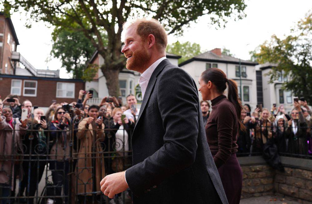 Britain's Prince Harry, Duke of Sussex and his wife Meghan, Duchess of Sussex, during a visit to the Himmah Hub, a food poverty community action group in Nottingham, central England. -AFP Photo