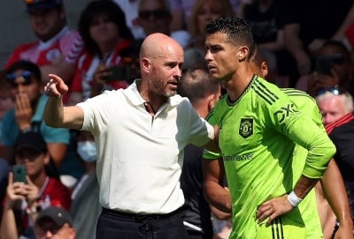 Manchester United's Dutch manager Erik ten Hag (L) and Cristiano Ronaldo (R). Photo by AFP