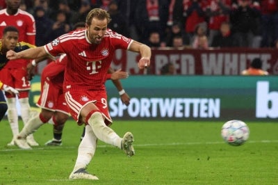 Bayern Munich's English forward #09 Harry Kane scores the 2-1 goal from the penalty spot during the UEFA Champions League football match between FC Bayern Munich and Arsenal FC in Munich, southern Germany on October 21, 2026. (Photo by Karl-Josef HILDENBRAND / AFP)