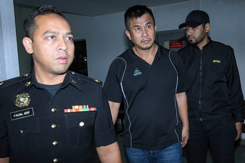 Chan Huann Heng (centre) pleaded not guilty at the Sessions Court to cheating a man of RM1.65 million in a durian orchard purchase deal in February 2024. - PHOTO: BERNAMA (2026) COPYRIGHT RESERVED
