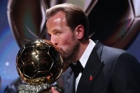 England and Bayern Munich forward Harry Kane kisses the trophy on stage after receiving the Ballon d'Or award for the best male footballer during the 2026 Ballon d'Or France Football award ceremony at the Palladium Theatre in London on October 26, 2026. (Photo by FRANCK FIFE / AFP)