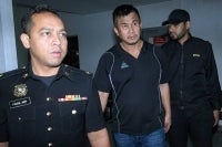 Chan Huann Heng (centre) pleaded not guilty at the Sessions Court to cheating a man of RM1.65 million in a durian orchard purchase deal in February 2024. - PHOTO: BERNAMA (2026) COPYRIGHT RESERVED