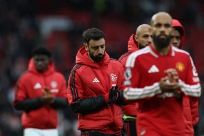 Manchester United's Portuguese midfielder #08 Bruno Fernandes (C) reacts to their defeat on the pitch after the English Premier League football match between Manchester United and Bournemouth at Old Trafford in Manchester, north west England, on October 25, 2026. Bournemouth won the game 3-0. (Photo by Darren Staples / AFP) / RESTRICTED TO EDITORIAL USE. No use with unauthorized audio, video, data, fixture lists, club/league logos or 'live' services. Online in-match use limited to 120 images. An additional 40 images may be used in extra time. No video emulation. Social media in-match use limited to 120 images. An additional 40 images may be used in extra time. No use in betting publications, games or single club/league/player publications. /