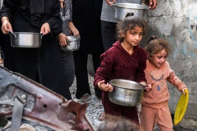 Children and others queue for meals at a charity kitchen in Jabalia refugee camp in northern Gaza, amid a food crisis that the Hind Rajab Foundation says was worsened by the destruction of a flour-producing facility. -AFP Photo