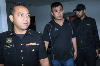 Chan Huann Heng (centre) pleaded not guilty at the Sessions Court to cheating a man of RM1.65 million in a durian orchard purchase deal in February 2024. - PHOTO: BERNAMA (2026) COPYRIGHT RESERVED