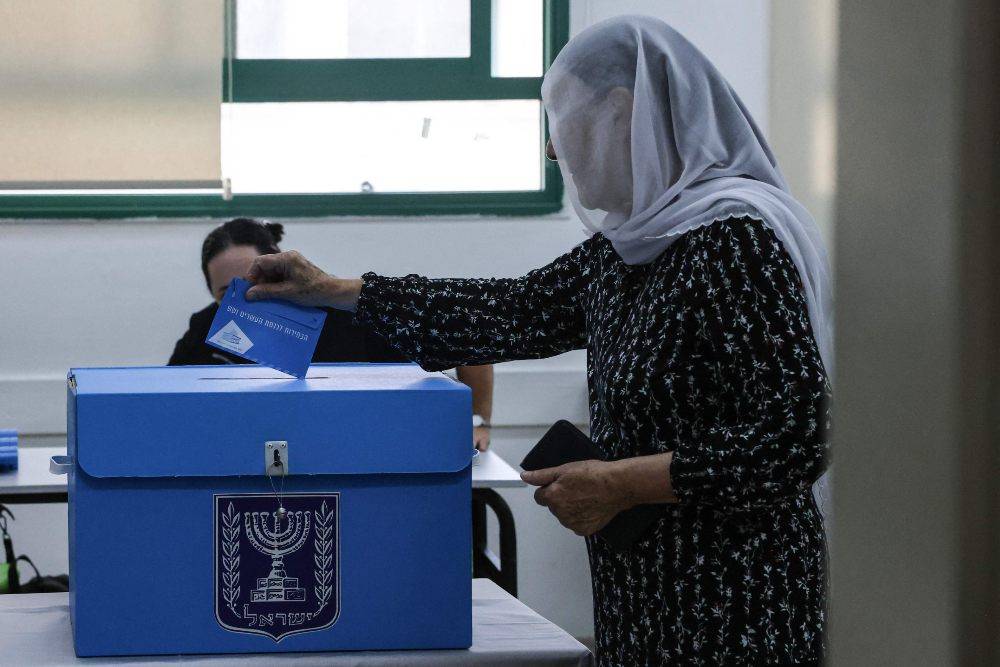 A woman casts her ballot at a polling station in the Druze village of Daliyat al-Karmel, in northern Israel. Photo by AFP