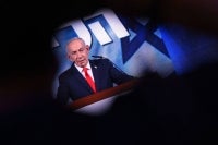 Israel's Prime Minister Benjamin Netanyahu addresses his supporters at the election night rally after the first exit polls were announced, in Jerusalem. Photo by AFP