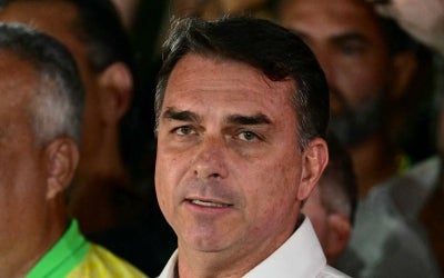 Brazil's right-wing senator and presidential candidate for the Liberal Party (PL) Flavio Bolsonaro reacts after knowing the first results in the presidential runoff election, in Brasilia, on October 25, 2026. (Photo by Pablo PORCIUNCULA / AFP)