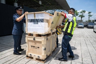 Members of the Royal Malaysian Customs Department display a computer server equipped with AI chips that was confiscated at Kuala Lumpur airport’s free trade zone, following a press conference in Sepang on October 28, 2026. (Photo by Mohd Rasfan / AFP)