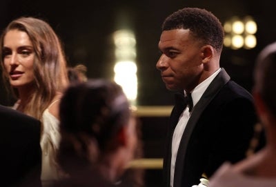 Real Madrid's Spanish forward #10 Kylian Mbappe (R) reacts during the 2026 Ballon d'Or France Football award ceremony at the Palladium Theatre in London on October 26, 2026. Kylian Mbappe apologised on October 27, 2026 after the Real Madrid star was dropped by major Chinese brands for apparently joking about Mao Zedong in a video that has gone viral. (Photo by FRANCK FIFE / AFP)