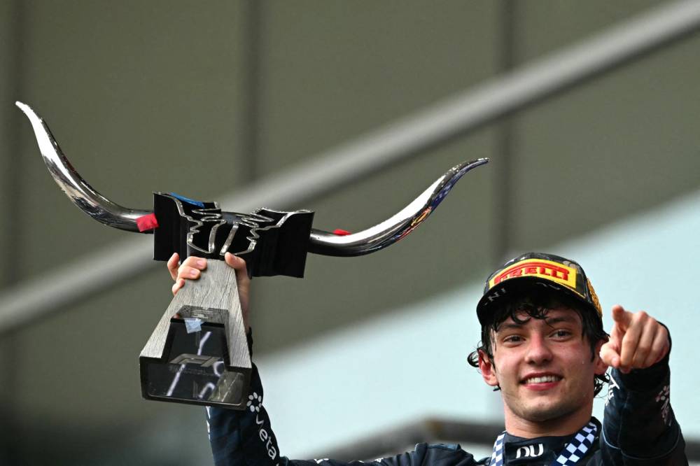 Race winner Mercedes' Italian driver Kimi Antonelli holds the trophy while celebrating on the podium at the conclusion of the United States Formula One Grand Prix at the Circuit of the Americas in Austin, Texas, on October 25, 2026. (Photo by RONALDO SCHEMIDT / AFP)