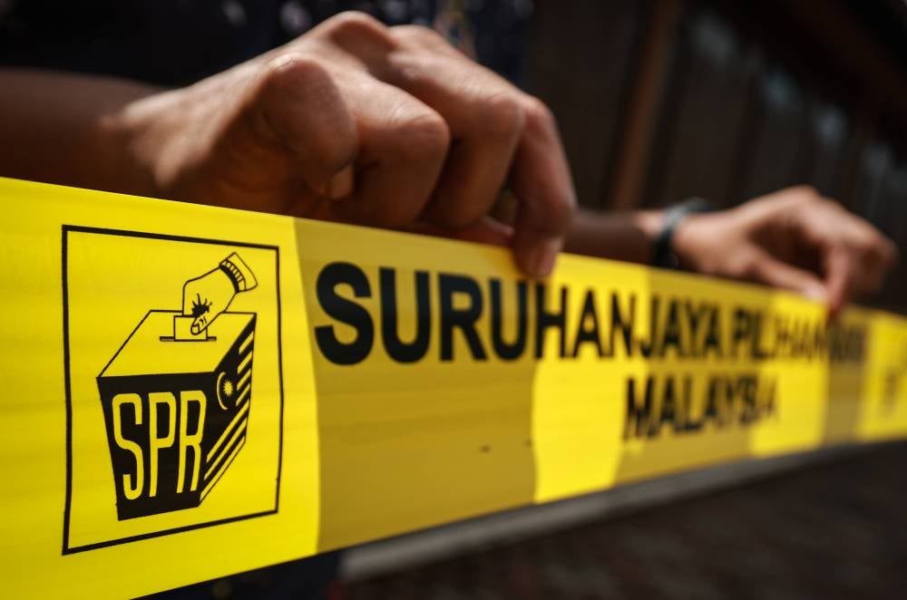 EC personnel making preparations for the candidate nomination process for the N17 Bukit Katil State Legislative Assembly seat at the nomination centre for the 16th Melaka state election at Dewan Tun Ali, Bukit Katil, today. - Photo by Bernama