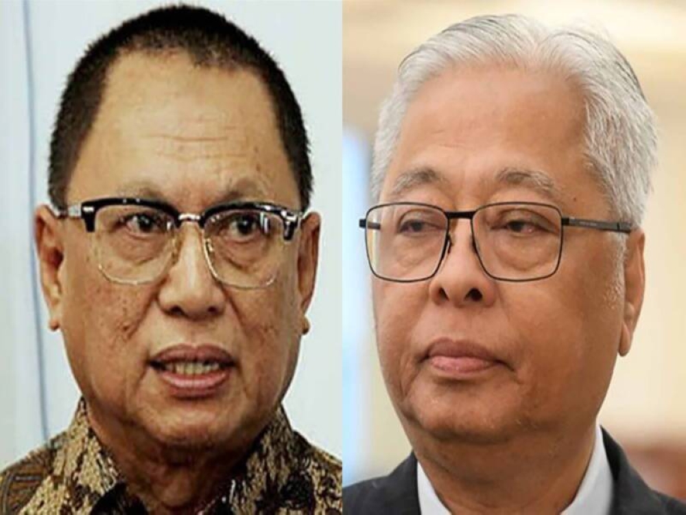 Cadangan Mohd Puad (kiri) supaya BN mendepani PRU15 tanpa mencalonkan sebarang 'poster boy' PRU15 dianggap melampau oleh sebilangan ahli MKT UMNO, pada saat Ismail Sabri sudah dipilih parti secara sebulat suara.