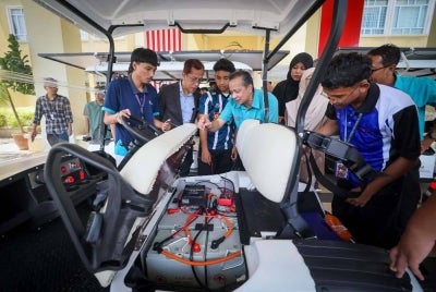 Mohd Zamre (dua dari kiri) melihat pelajar semester tiga Diploma Kejuruteraan Elektrik (tenaga hijau) mengemaskini projek panel solar yang dipasang pada kereta buggy pada sesi demonstrasi dan promosi Projek Inovasi Teknologi Solar Buggy Car di Politeknik Jeli hari ini.