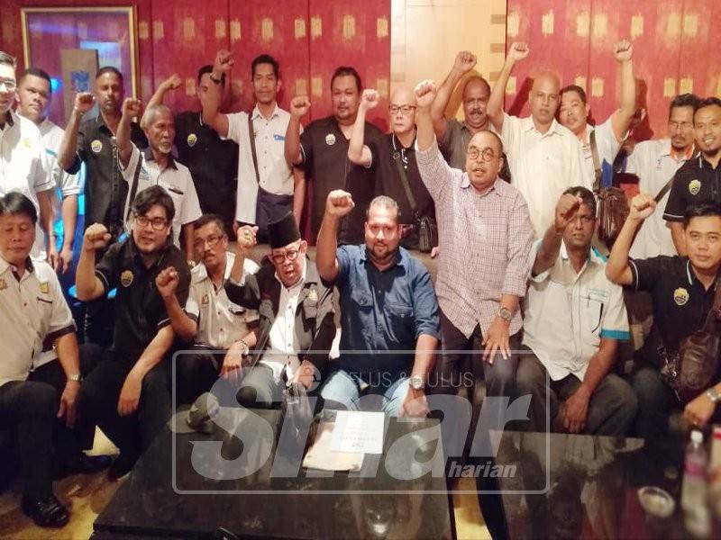 Kamarudin (empat dari kanan) dan Shamsubahrin (tiga dari kanan) bersama wakil-wakil persatuan teksi yang hadir semasa sidang media hari ini.