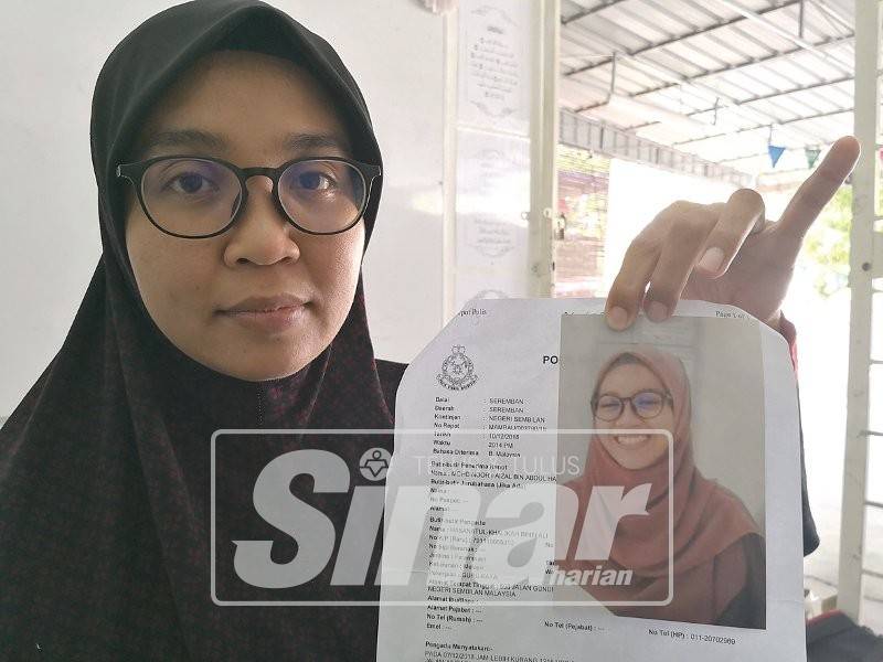 Hasanatul Kalikah menunjukkan laporan polis yang dibuat berserta gambar anaknya itu.